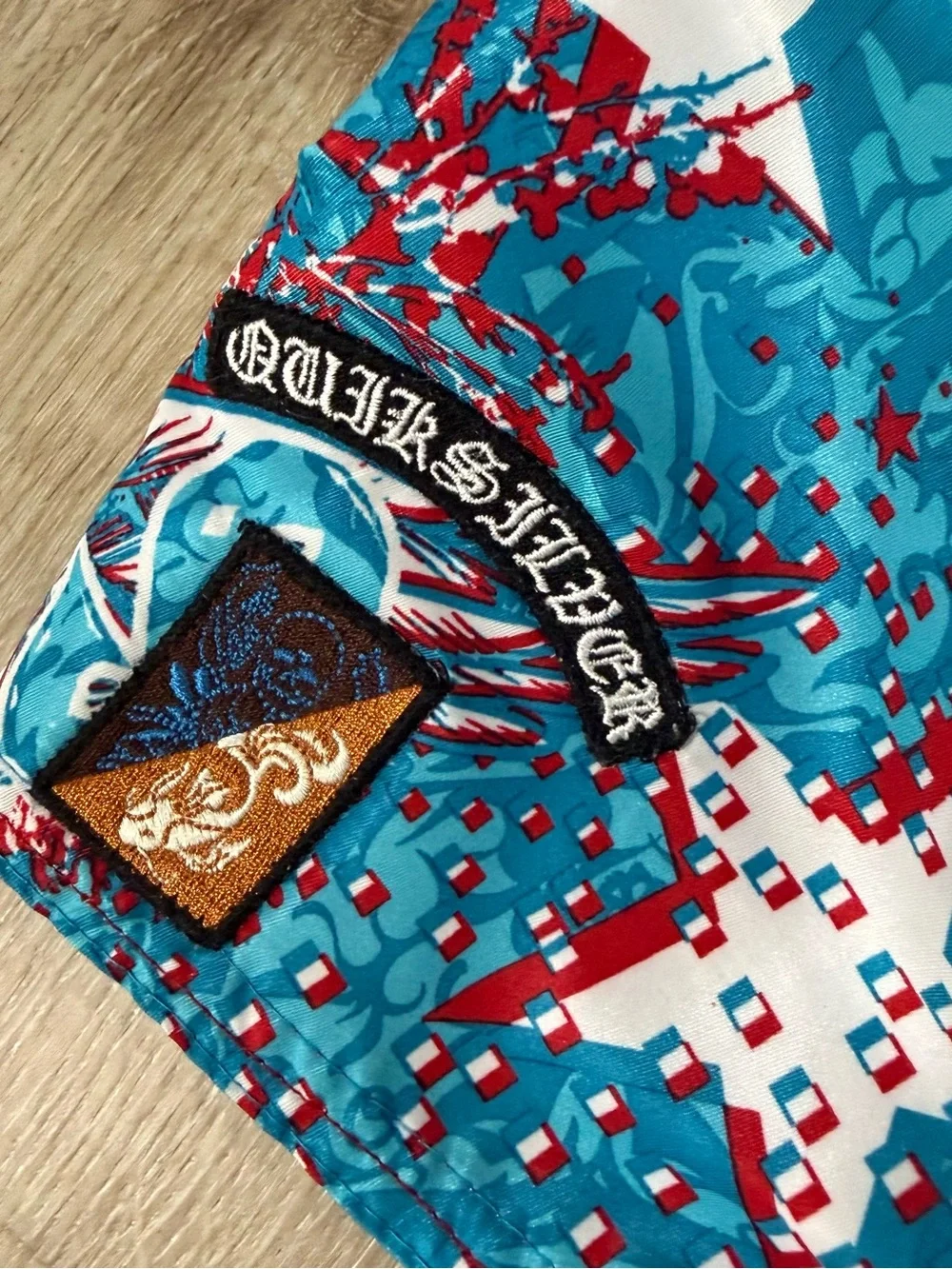 Quiksilver Turquoise & Red Winged Skull Print Swim Trunks